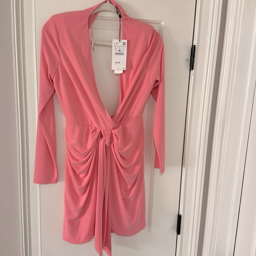 Brand new, never worn, great pink dress. Low cut in front and open back.